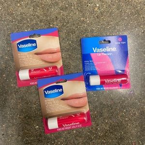 Three Vaseline lip balms.
